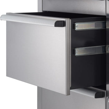 A close-up shot shows a partially open stainless steel drawer with a long, horizontally ribbed handle. The drawer slides out on visible metal tracks, revealing a dark interior.