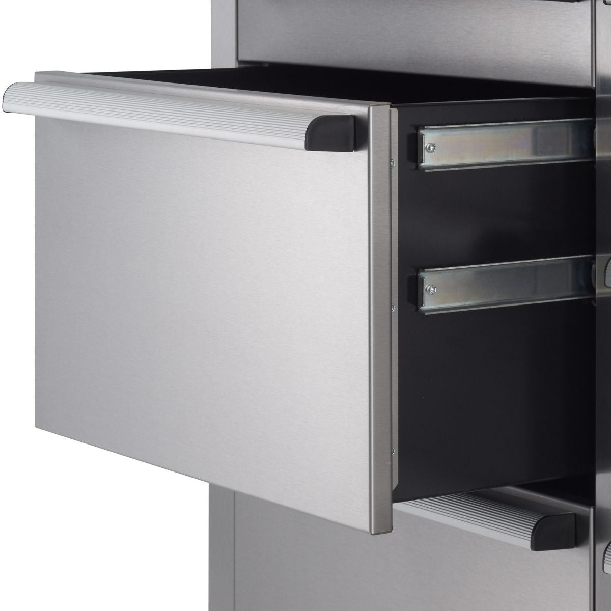 A close-up shot shows a partially open stainless steel drawer with a long, horizontally ribbed handle. The drawer slides out on visible metal tracks, revealing a dark interior.