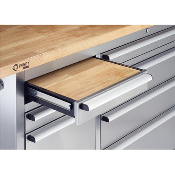 A close-up shows a partially extended wooden slide-out work surface from a stainless steel rolling workbench. The workbench has multiple drawers with long, horizontal handles and a thicker wooden top.