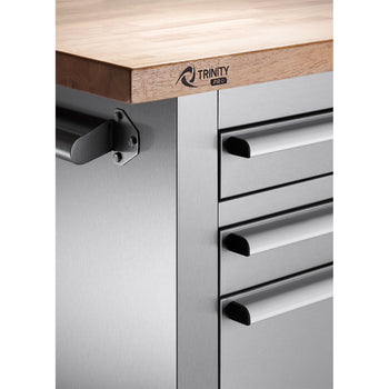 A close-up shot shows the corner of a Trinity PRO workbench. The workbench features a light-colored wooden top with the 