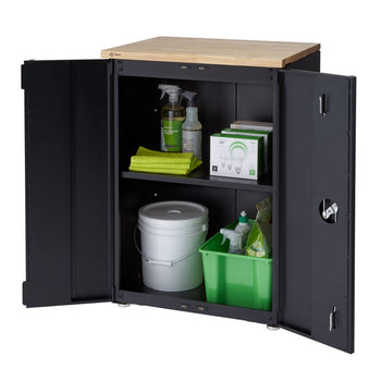A black steel garage cabinet with its doors open, revealing two shelves stocked with various household and cleaning supplies. The cabinet has a light-colored wooden top surface.