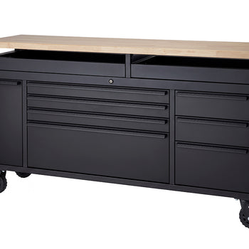 A matte black mobile tool workbench featuring a solid wood top and heavy-duty locking casters is shown completely empty against a plain white studio background. All of its drawers, side cabinets, and open top storage compartments are fully closed to showcase its sleek, streamlined design.