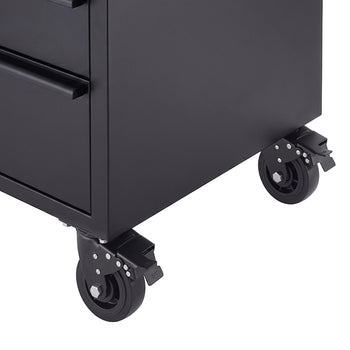 A close-up shot focuses on the lower corner of a matte black tool workbench showing its heavy-duty caster wheels. The dark swivel wheels feature integrated foot-operated brake levers to lock the unit securely in place.