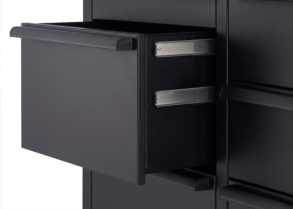 A close-up view highlights a sturdy, matte black handle bolted to the side of a black tool cabinet. Just above the handle, the edge of a thick wooden workbench top features the branded "TRINITY PRO" logo.