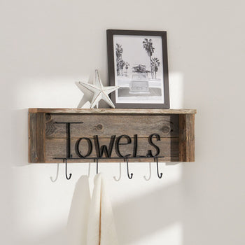 A rustic wooden shelf with black metal lettering spelling 