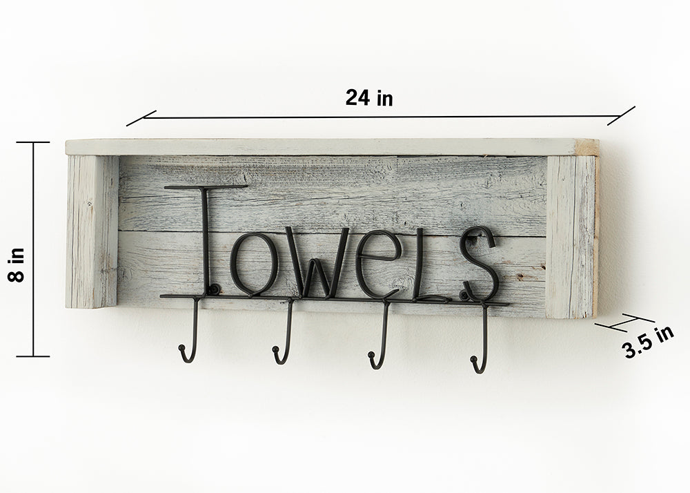 A rustic wooden towel rack with a shelf and four metal hooks is mounted on a white wall. The word "Towels" is spelled out in decorative black metal lettering above the hooks.