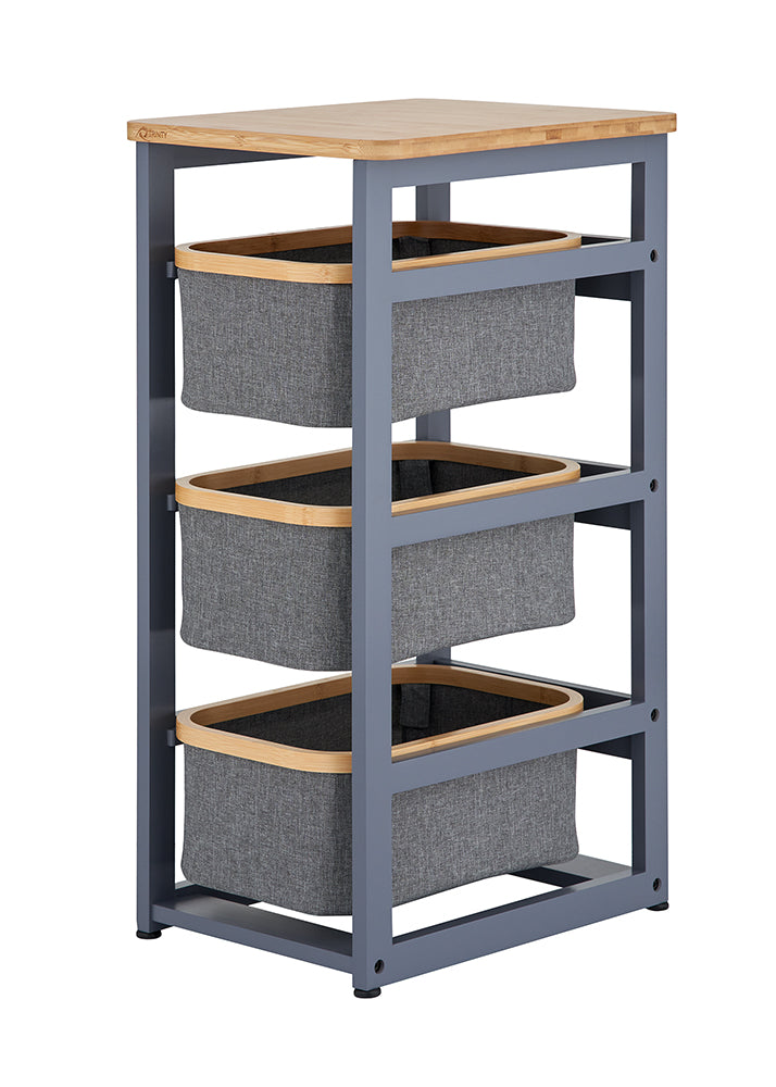 A narrow, three-tier storage organizer features a grey metal frame and a light wood-grain top surface. Each level holds a removable grey fabric basket accented with a matching wooden rim.