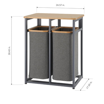 A laundry hamper with two separate fabric baskets and a wooden top. The dimensions are included: the height is 30.43 inches, the width is 24.57 inches, and the depth is 17.32 inches.