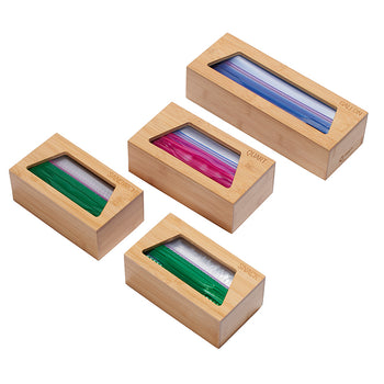 A set of four bamboo storage boxes, each designed to hold different sizes of plastic bags. The boxes are labeled 