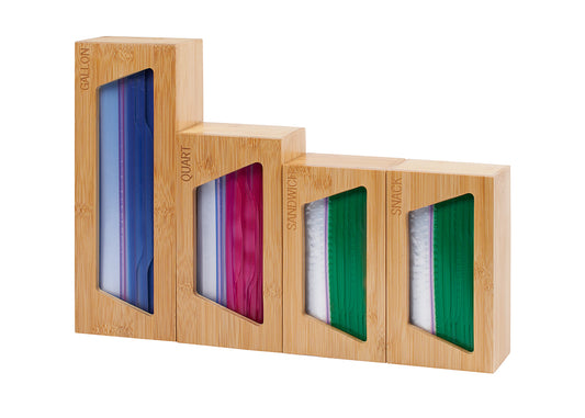 A light-colored wooden organizer with four compartments holds different sizes of plastic storage bags. The compartments are labeled "GALLON," "QUART," "SANDWICH," and "SNACK" and are arranged in descending height from left to right.