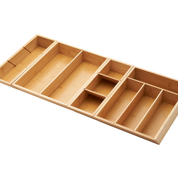 A bamboo drawer organizer is shown from an overhead perspective, with multiple compartments to store cutlery and other kitchen utensils. The organizer is extended to its full length, revealing additional compartments on the sides.