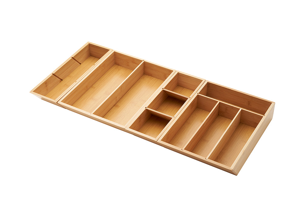 A bamboo drawer organizer is shown from an overhead perspective, with multiple compartments to store cutlery and other kitchen utensils. The organizer is extended to its full length, revealing additional compartments on the sides.