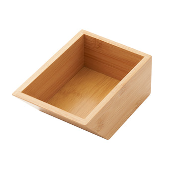 A light-colored, empty wooden box made of bamboo. The box has a slanted top opening, with the front side being lower than the back.