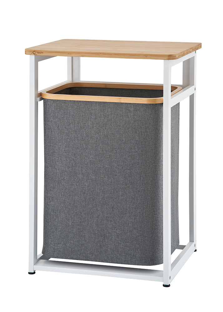 A minimalist laundry hamper stand features a white metal frame, a flat wooden tabletop, and a removable dark grey fabric basket. The product is shown completely empty against a plain white background.