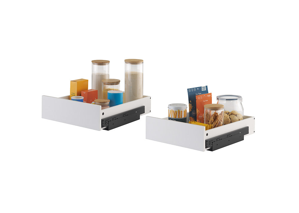Two white pull-out organizer drawers equipped with black side-mounting tracks are filled with pantry items against a plain background. The left drawer holds tall glass storage canisters and food boxes, while the right drawer contains snack pouches, cookie jars, and a tin of wafer sticks.