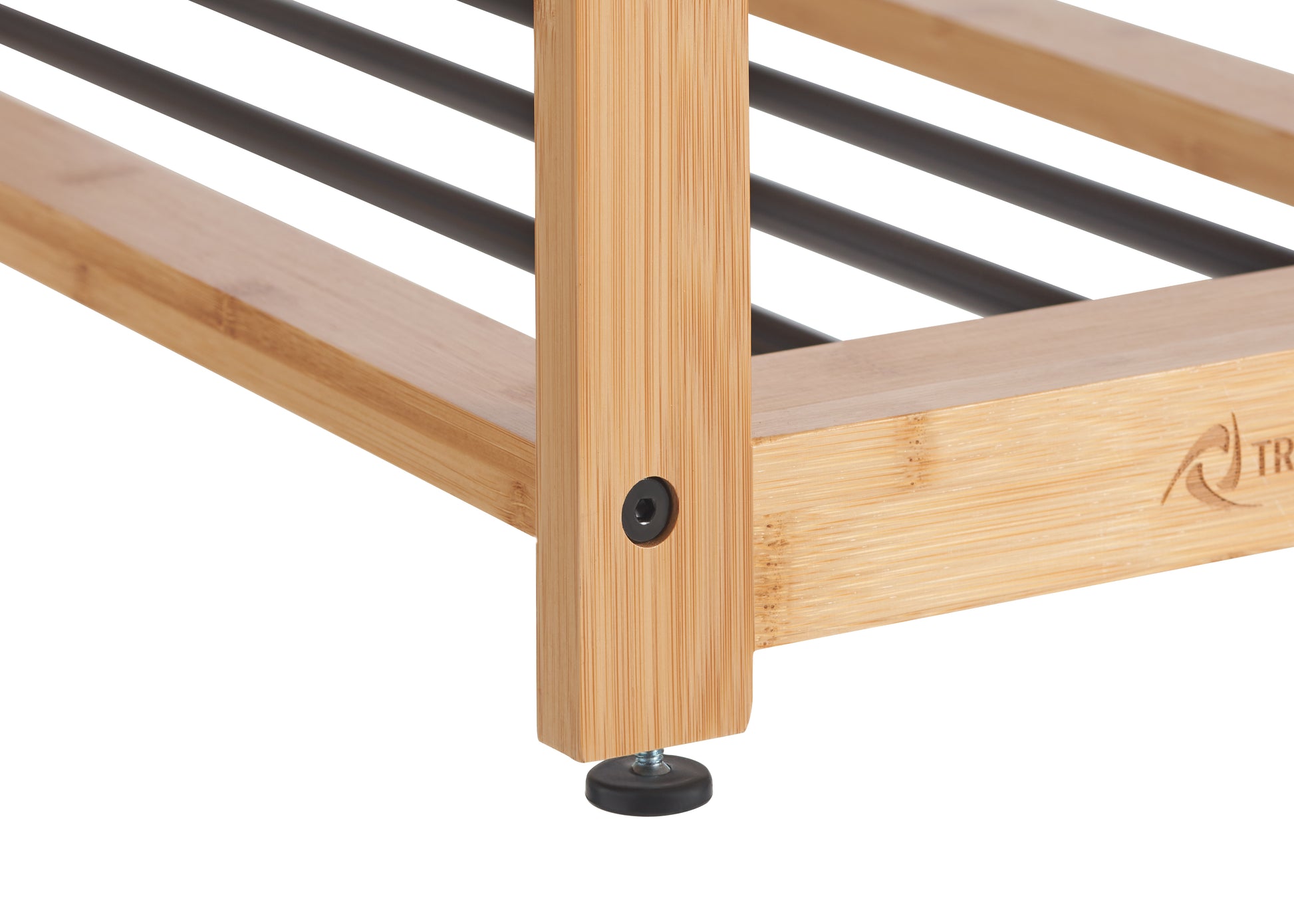 A close-up of the bottom corner of a light brown, wooden shoe rack. The rack is made of what appears to be bamboo with black metal rods forming the shelves and has a black, adjustable foot on one of the legs.
