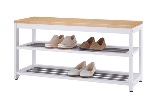 A white three-tier shoe rack with a light wood top. Four pairs of shoes, including tan slip-ons and white and brown woven flats, are neatly stored on the two shelves.