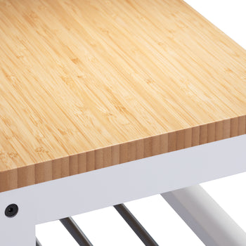 A close-up of a wooden bench with a light-colored bamboo top and a white metal frame. Black screws are visible where the wooden top is attached to the metal legs.