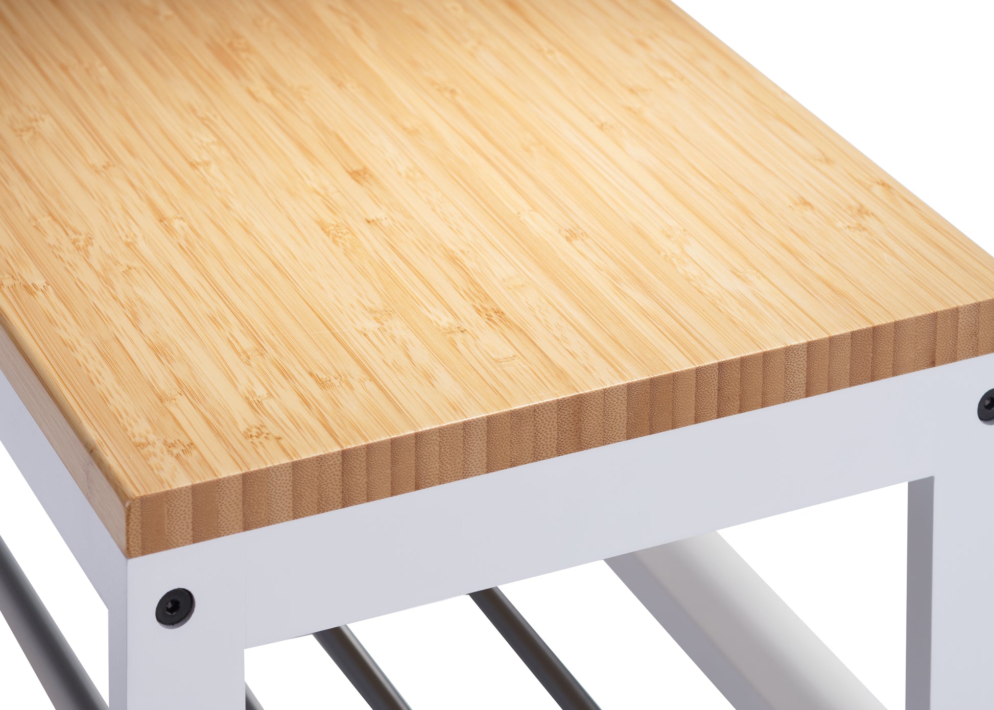 A close-up of a wooden bench with a light-colored bamboo top and a white metal frame. Black screws are visible where the wooden top is attached to the metal legs.