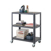 A dark gray metal utility cart with three shelves is shown against a white background. The cart is filled with various office and art supplies, including notebooks, pens, and paper organizers.