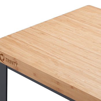A close-up shot shows the corner of a light-colored bamboo countertop with the 