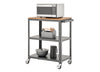 A three-tiered rolling utility cart with a dark gray metal frame and a light wood top shelf. A stainless steel microwave sits on the top, and the two lower shelves hold various kitchen items like bowls, a thermos, and a utensil caddy.