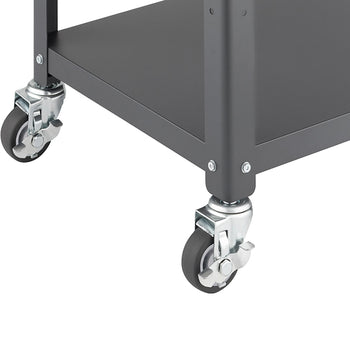 Close-up of the bottom corner of a dark gray metal utility cart, showing two of its four rubber swivel casters. The casters are silver, feature a locking mechanism, and are attached to the cart's square metal legs with screws.
