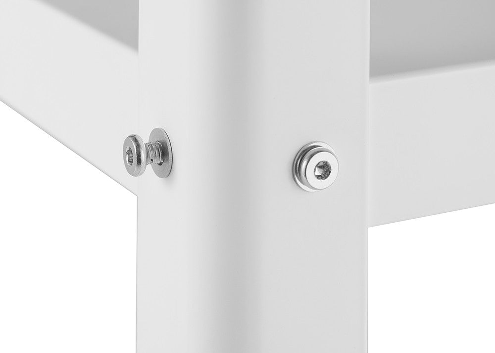 A close-up shot of a white metal structure, possibly furniture, shows two silver bolts securing a joint. The bolts are centered on the frame and stand out against the white background.
