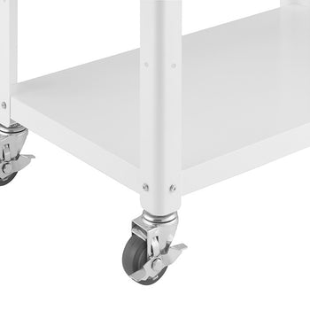 A close-up shot of the white metal frame and wheels of a kitchen cart. The cart has two shelves, and the wheels are gray with locking mechanisms.