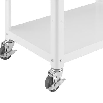 A close-up shot shows the bottom corner of a white metal kitchen cart. Two wheels with gray rubber tires and silver metal casters are visible, one with a locking mechanism engaged. The cart has a flat, white metal shelf above the wheels.