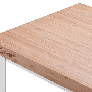 A close-up, angled shot shows the corner of a light bamboo butcher block countertop with the 