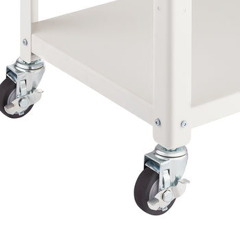 Close-up shot of the lower section of a white metal utility cart, focusing on two of the swivel caster wheels. The wheels feature black rubber treads and bright silver-toned metal mounting brackets, one of which has an activated locking lever.