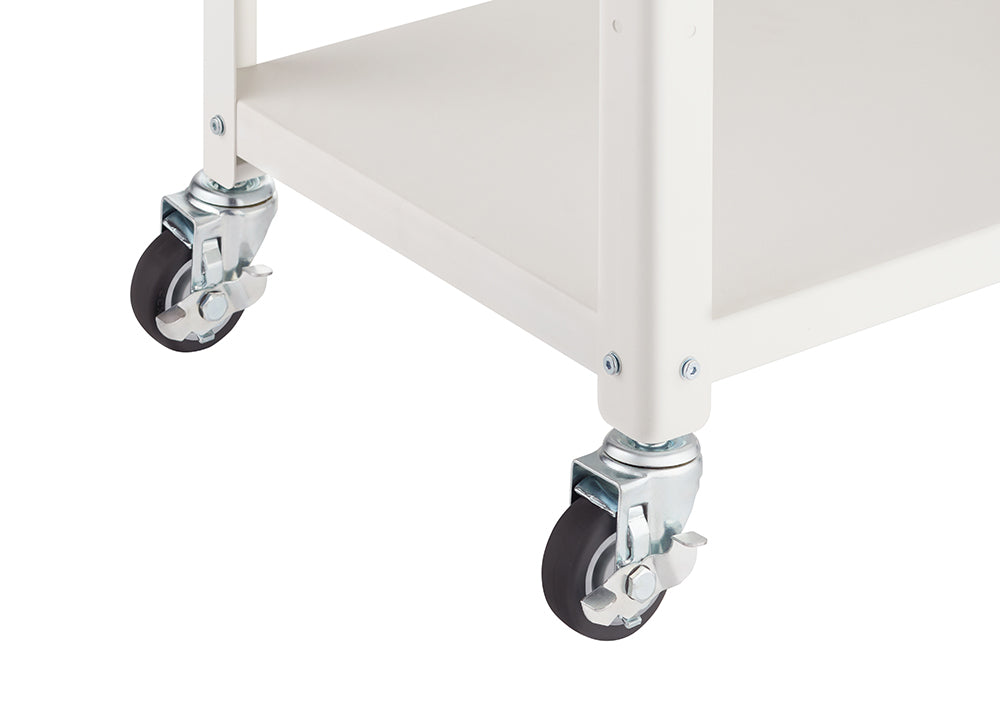 Close-up shot of the lower section of a white metal utility cart, focusing on two of the swivel caster wheels. The wheels feature black rubber treads and bright silver-toned metal mounting brackets, one of which has an activated locking lever.