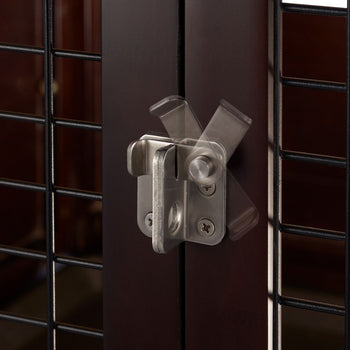 A close-up shows a silver, stainless steel slide gate latch affixed to a dark brown wooden door or gate. The latch is in a partially open position, with motion blur indicating its sliding mechanism.