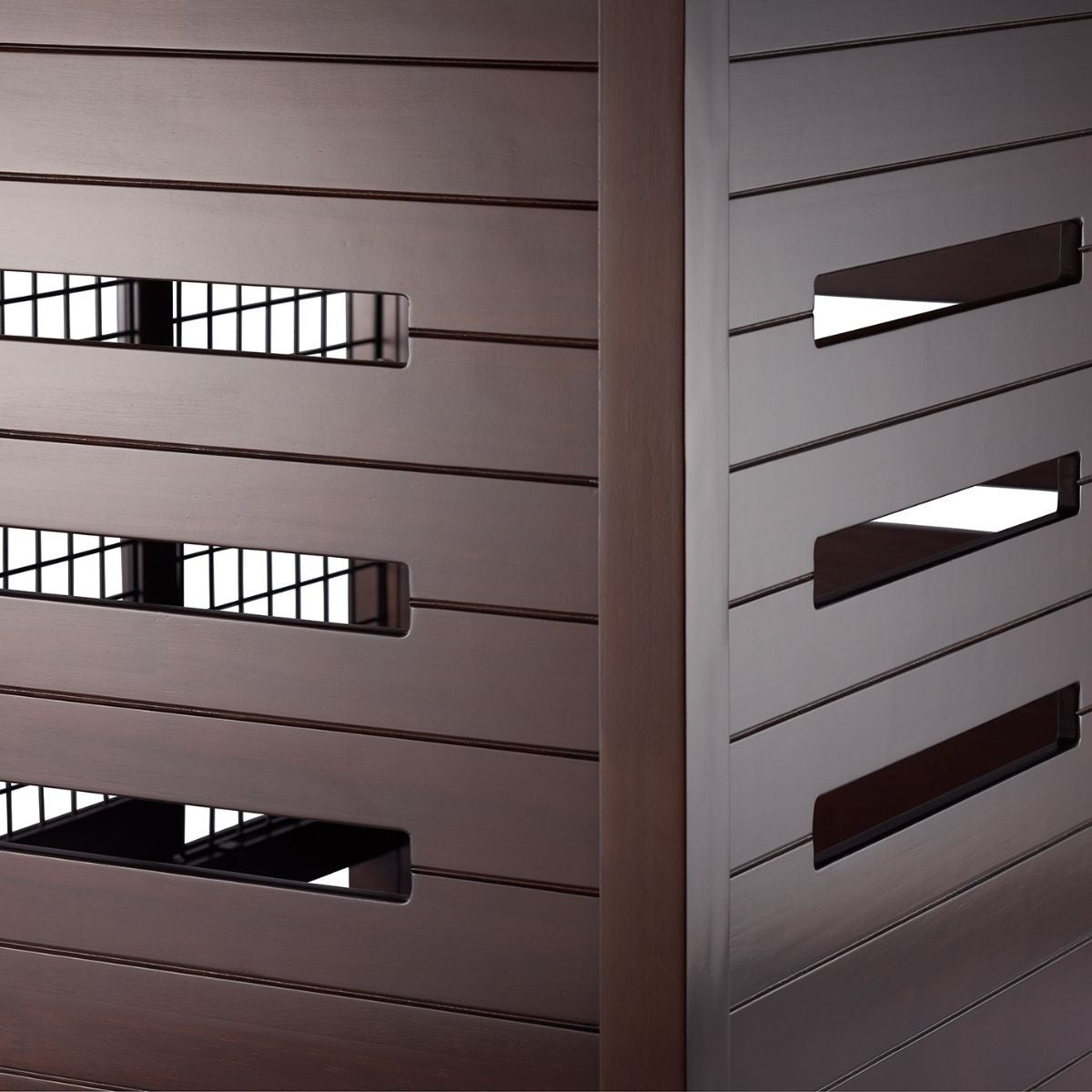 A close-up shows the slatted brown exterior of what appears to be a pet crate accent table. Rectangular openings on one side reveal a wire mesh interior, while the other visible side features longer, angled rectangular openings.