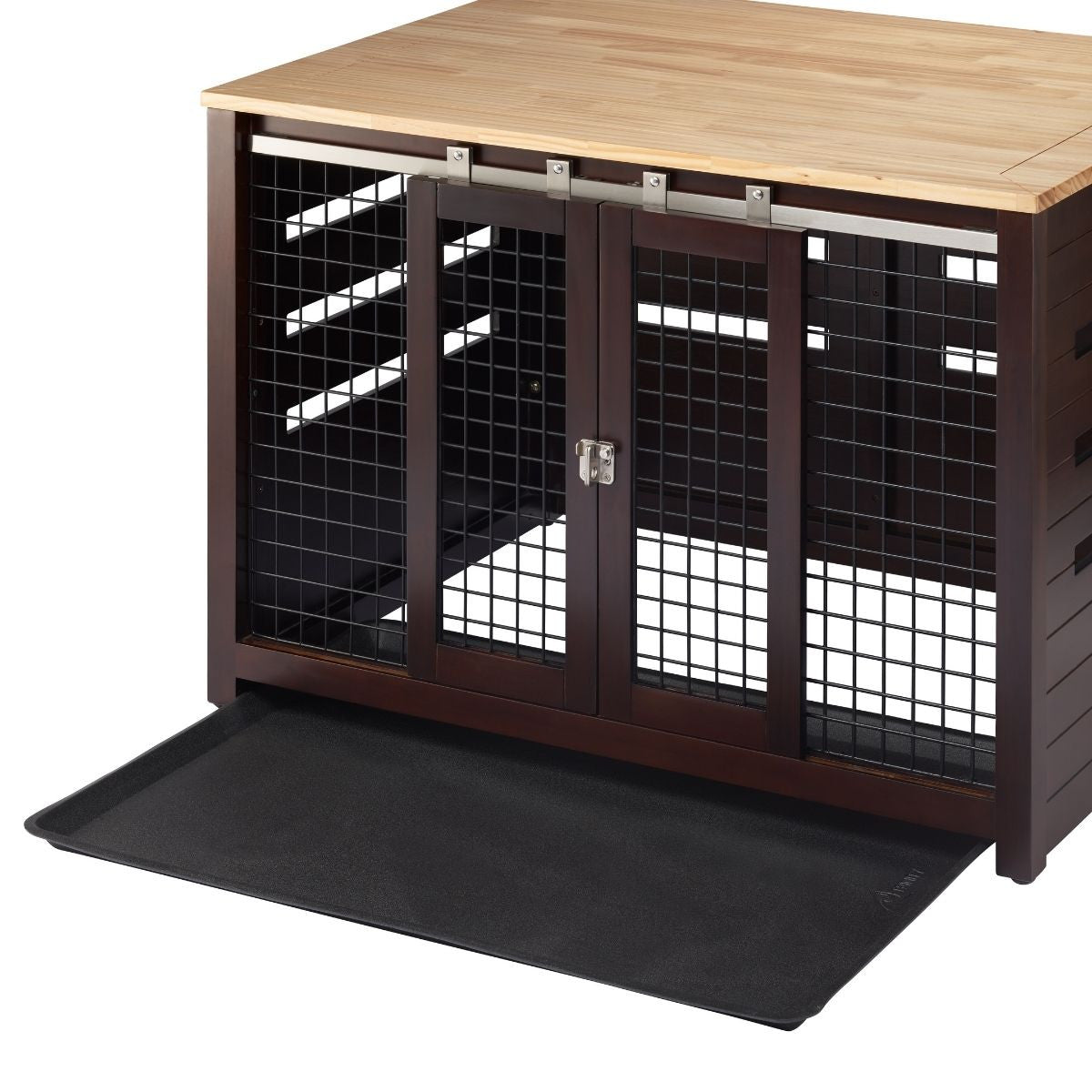 A brown wooden pet crate with a light brown wooden top functions as an accent table. The crate features sliding metal doors and a black plastic tray that has been partially pulled out from underneath.
