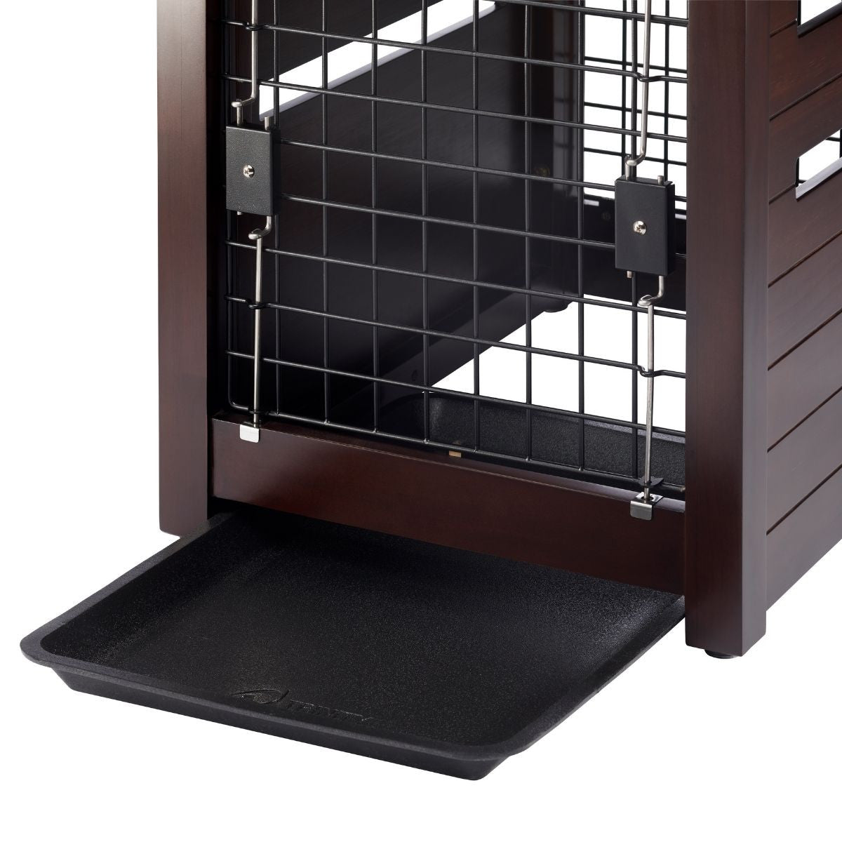 A close-up shot shows the bottom section of a dark brown wooden pet crate. A black plastic tray slides out from the bottom of the crate, designed to catch any spills or messes.