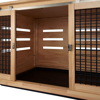 A light wood pet crate with sliding doors is shown. The side doors are made of black metal bars, while the back has horizontal slats for ventilation.