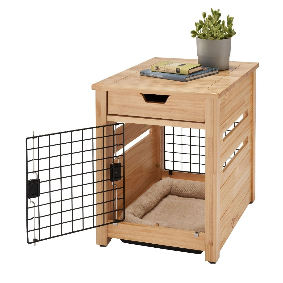 A light brown wooden pet crate end table with a black wire mesh door swung open is shown against a white background. The table has a drawer at the top and a soft beige pet bed inside the crate area.