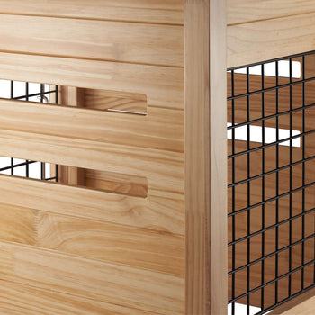 A close-up shows the corner of a light brown wooden storage unit with horizontal slats and rectangular handle cutouts on the left side. To the right, a black wire mesh shelf is visible, suggesting multiple tiers within the unit.