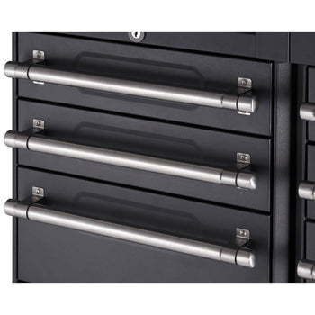A close-up shows three closed drawers of a dark gray or black metal cabinet. Each drawer features a long, cylindrical, brushed silver handle attached horizontally with small, rectangular mounting plates.