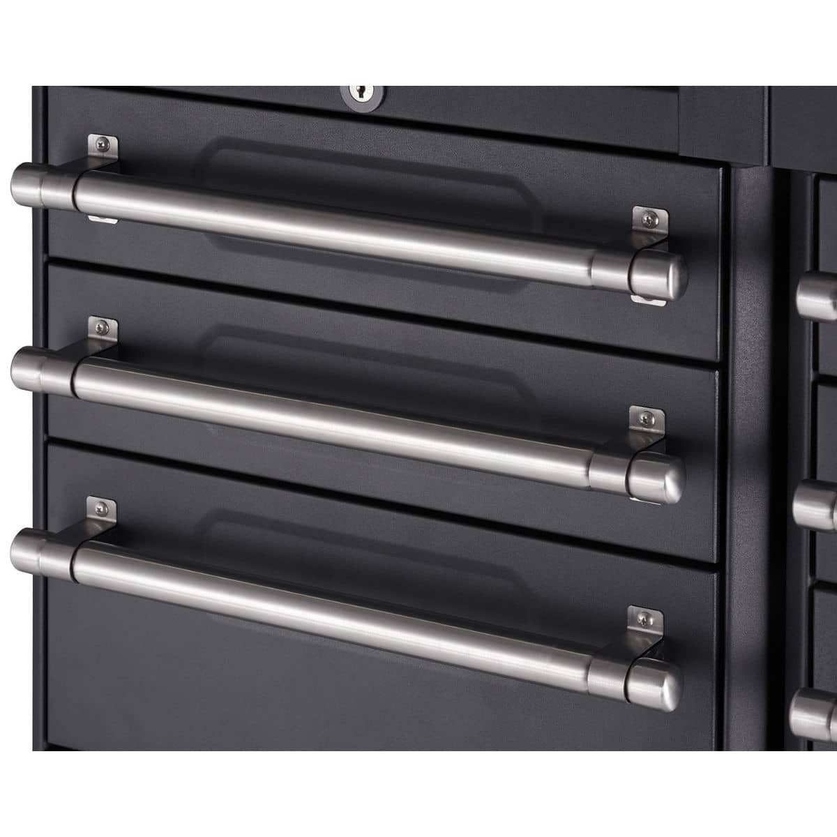 A close-up shows three closed drawers of a dark gray or black metal cabinet. Each drawer features a long, cylindrical, brushed silver handle attached horizontally with small, rectangular mounting plates.