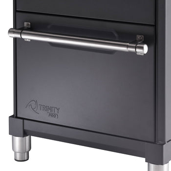 A close-up shot shows a section of a dark gray Trinity Pro garage base cabinet with drawers. A long, cylindrical, stainless steel handle is horizontally mounted on the front of a drawer.