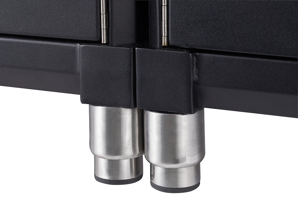 Close-up of two cylindrical stainless steel legs supporting a black cabinet. The legs have black, conical feet, and the cabinet itself appears to be made of a dark, possibly metallic, material.