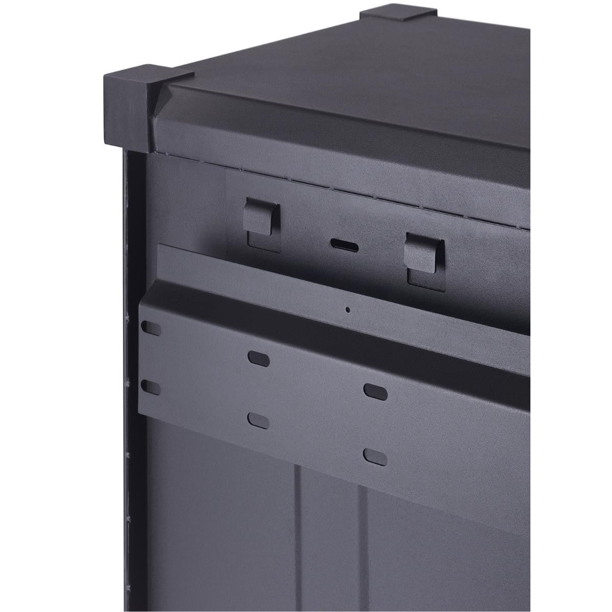 A close-up shot focuses on the corner of a dark gray, industrial-style metal cabinet, possibly part of a garage storage system. Visible are the top surface with a raised edge, the side panel showing mounting holes, and a horizontal support bracket with oval cutouts.