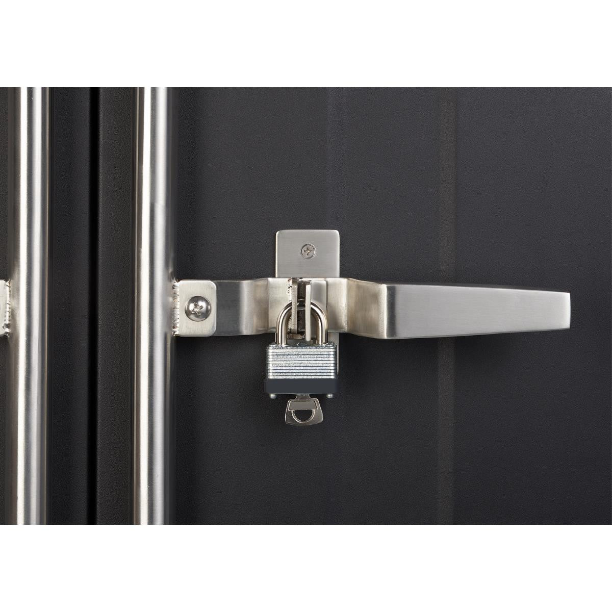 A close-up shows a silver padlock securing the latch of a dark-colored metal storage cabinet. The latch mechanism features a horizontal handle and is affixed to the cabinet door with visible screws.
