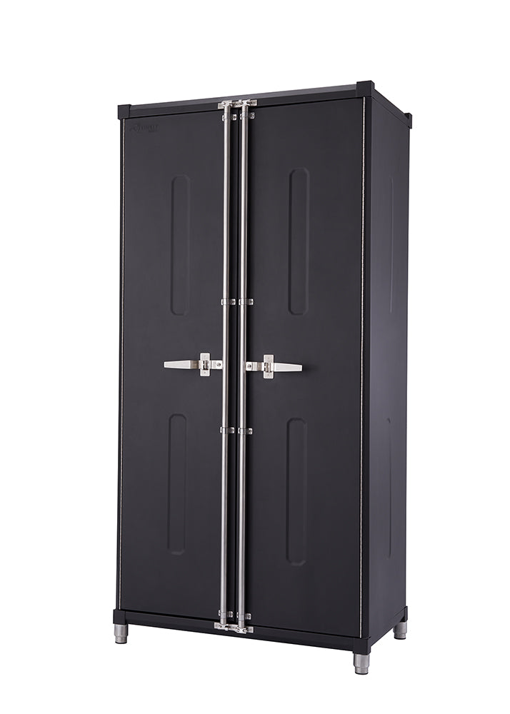 A sleek, dark gray or black storage cabinet with two doors stands on four silver cylindrical feet. The doors feature silver-colored latches and long, vertical recessed panels, suggesting a modern and robust design.