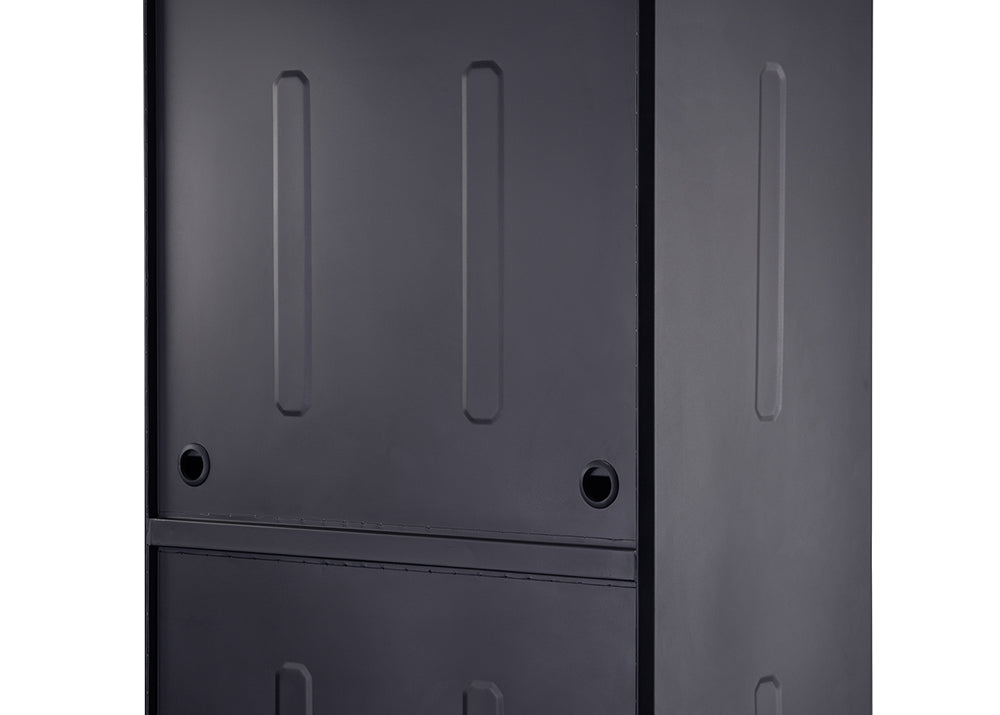 A close-up shot shows a dark grey or black metal surface, possibly a cabinet or appliance, with subtle raised rectangular designs. Two circular, dark holes are visible on the surface, one on the left and one further to the right.