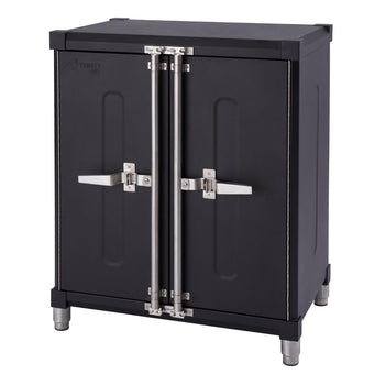 A black Trinity Pro garage cabinet with two doors and silver handles is shown against a white background. The cabinet has adjustable silver-colored legs and visible hinges and latching mechanisms on the doors.