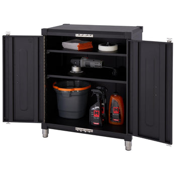 A black 18-gauge steel garage base cabinet with two open doors reveals three shelves containing car detailing supplies. The supplies include buffing pads, a power buffer, a bucket, and bottles of cleaning solutions.